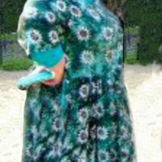 A woman in a green dress holding something.