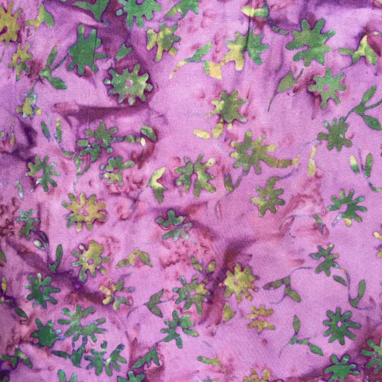A close up of the fabric with green leaves