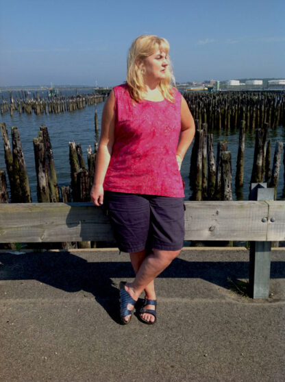 A woman standing on the side of a pier.