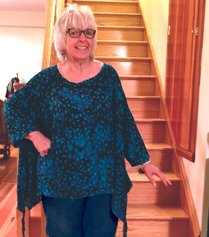 A woman standing in front of some stairs