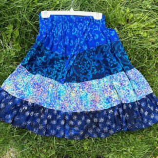 A blue skirt is sitting on the grass.