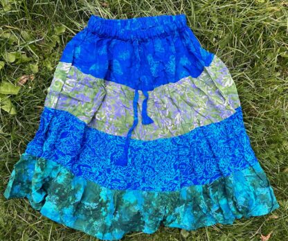 A blue skirt is sitting on the grass.