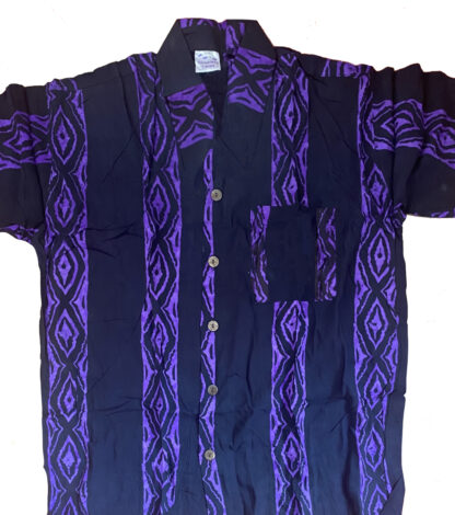 A purple and black shirt is shown on the ground.