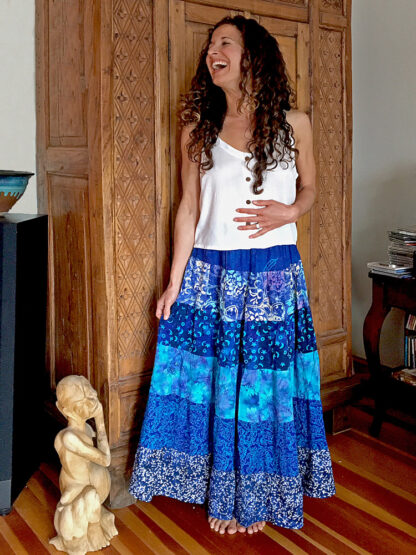 A woman standing in front of a wooden door.