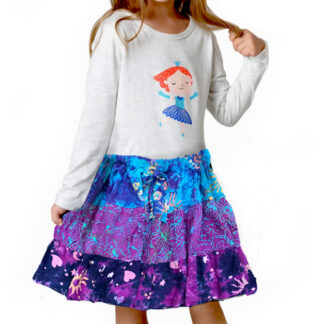 A girl wearing a skirt and shirt with the image of ariel.