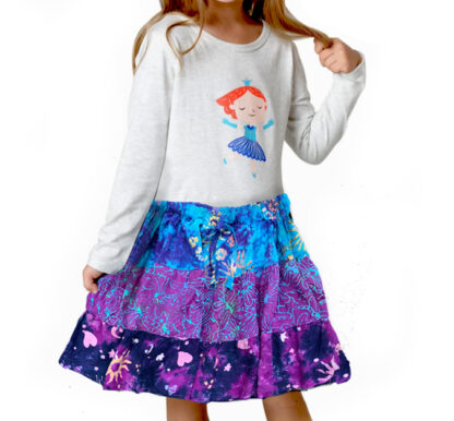 A girl wearing a skirt and shirt with the image of ariel.