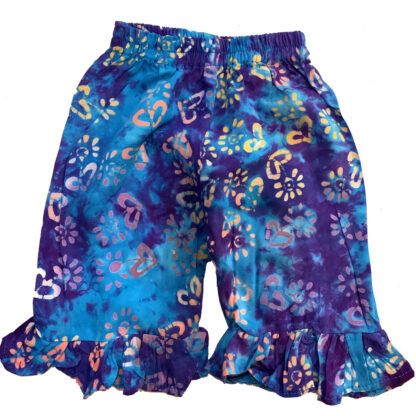 A pair of blue shorts with colorful flowers.