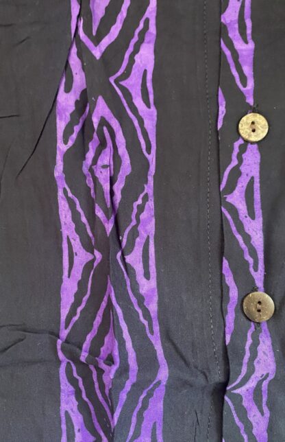 A close up of buttons on the sleeve of a shirt.