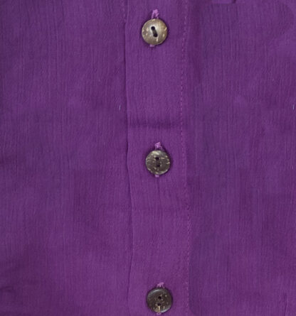 A purple shirt with buttons on the front.